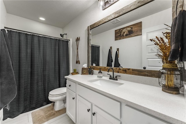 bathroom featuring toilet, vanity, tile patterned flooring, and a shower with curtain