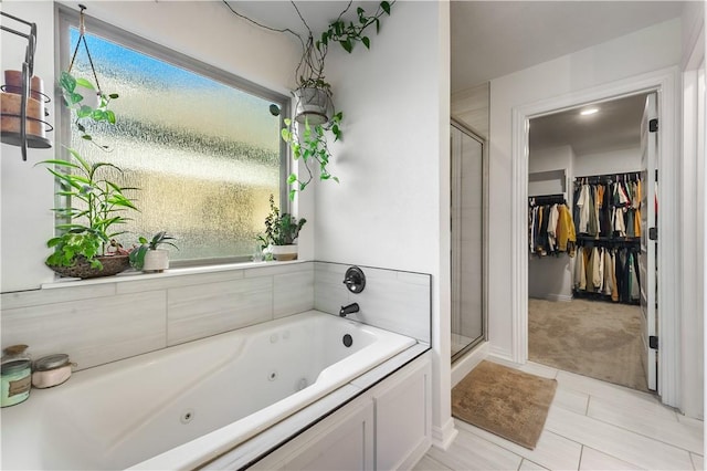 bathroom featuring tile patterned flooring and plus walk in shower