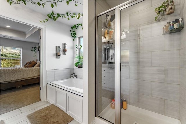 bathroom featuring tile patterned flooring and shower with separate bathtub