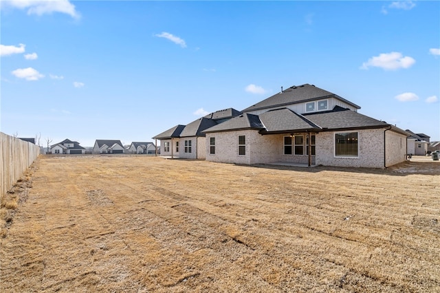 rear view of house featuring a lawn