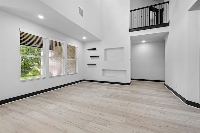 unfurnished living room featuring light hardwood / wood-style flooring