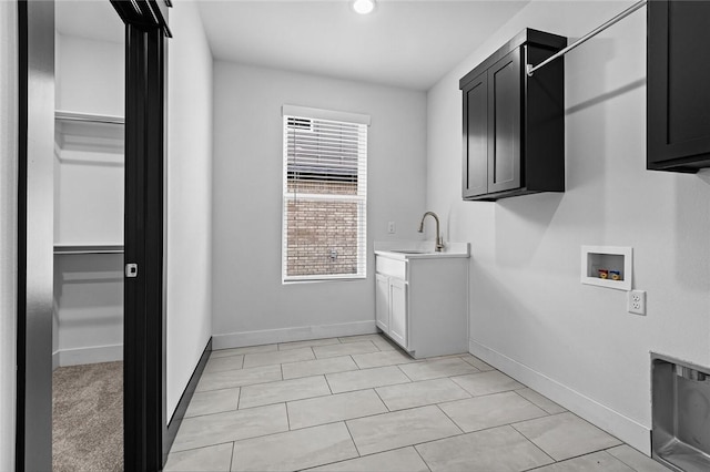 laundry room with washer hookup, sink, light tile patterned floors, and cabinets