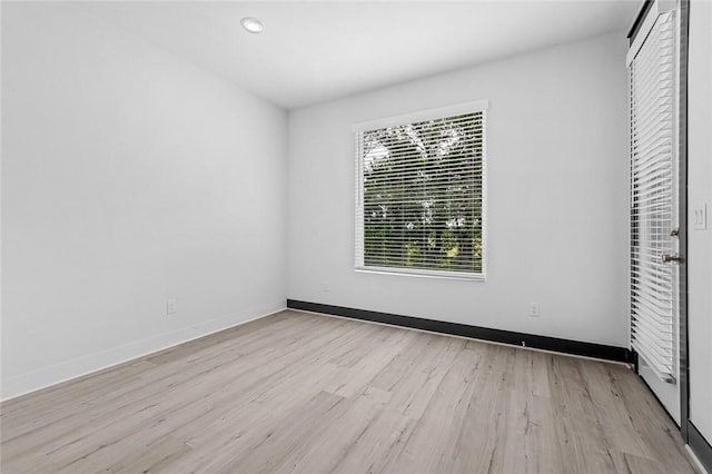 unfurnished bedroom featuring light wood-type flooring and a closet