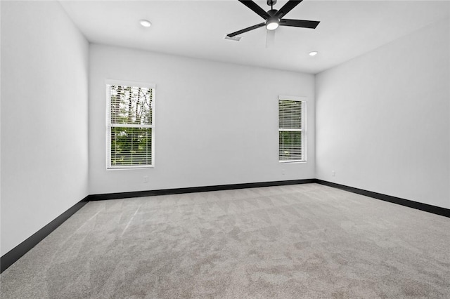 carpeted spare room with ceiling fan