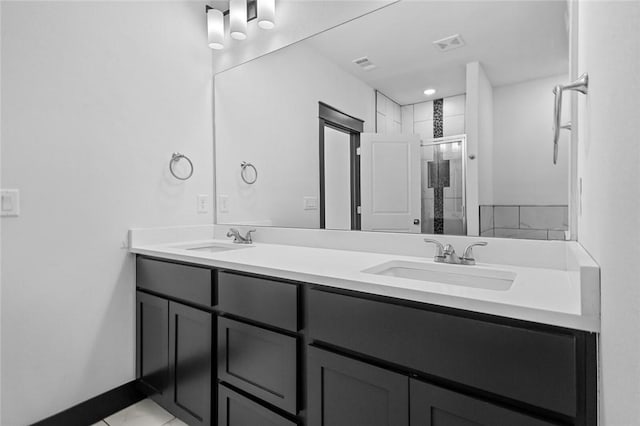 bathroom with tile patterned floors, an enclosed shower, and vanity