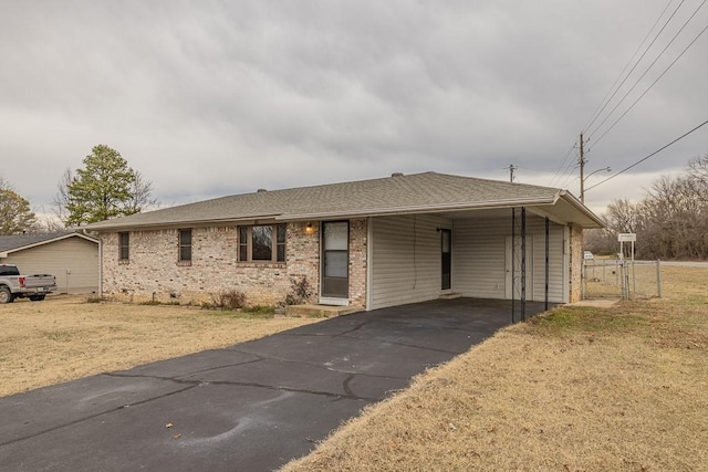 view of front facade with a front yard and a carport