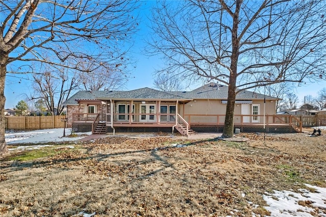 snow covered property featuring a deck