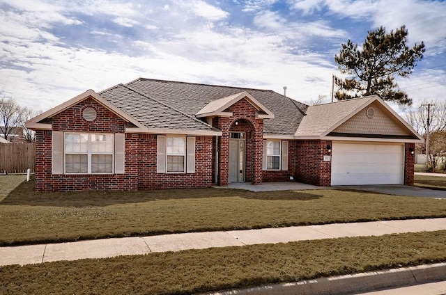 ranch-style home with a front yard and a garage