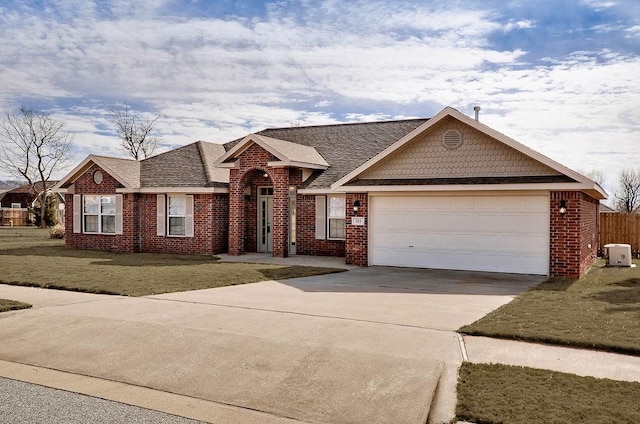 single story home with a garage and a front yard