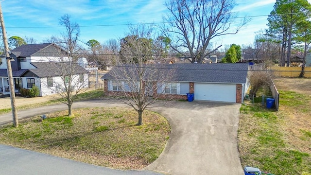 ranch-style home with a garage and a front lawn