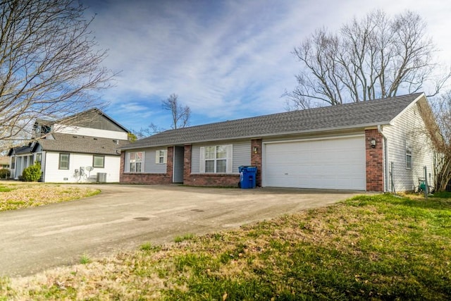 single story home with central AC unit, a garage, and a front lawn