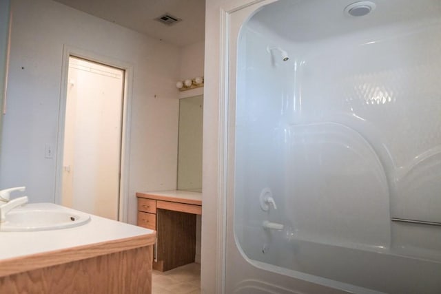 bathroom featuring vanity and  shower combination