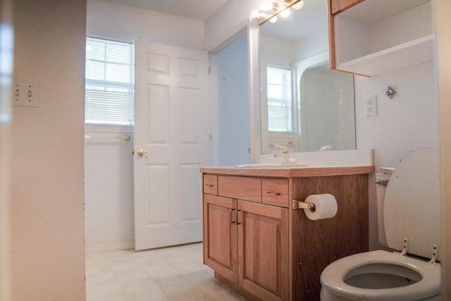 bathroom with vanity, plenty of natural light, and toilet