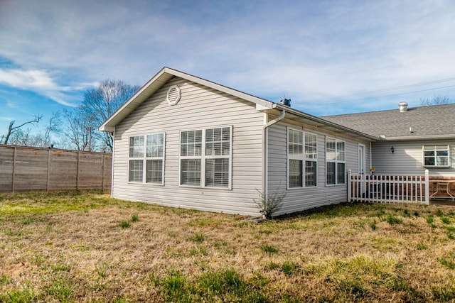 rear view of property with a lawn