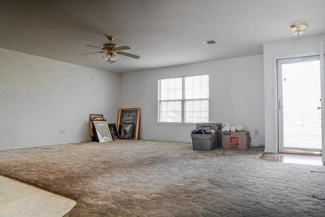 misc room with ceiling fan and carpet flooring