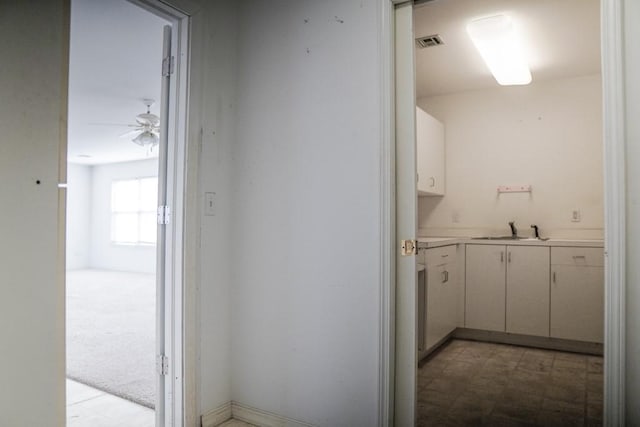 interior space with sink and ceiling fan