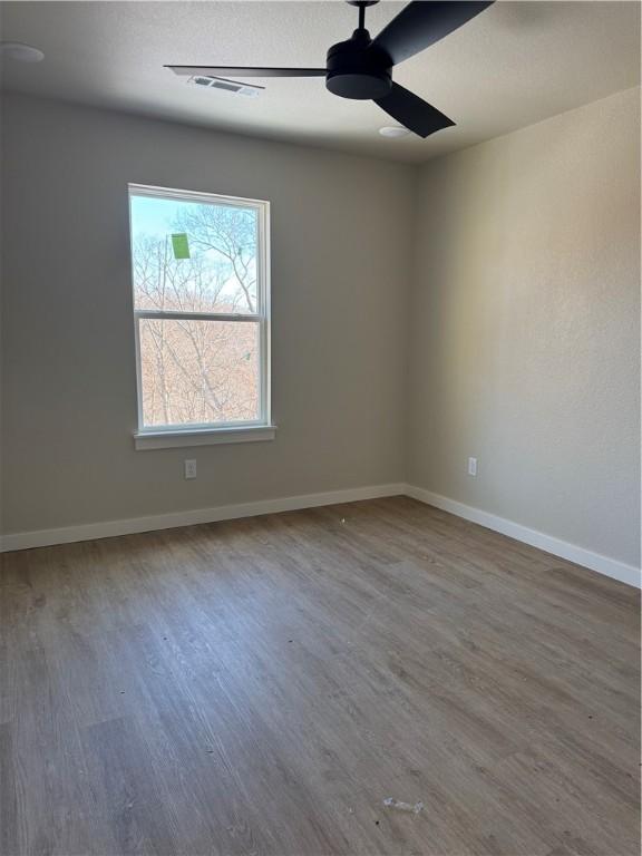 spare room featuring ceiling fan and hardwood / wood-style floors