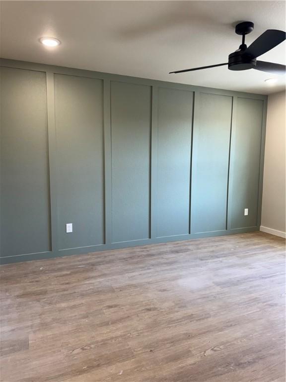 interior space featuring ceiling fan, two closets, and light hardwood / wood-style flooring