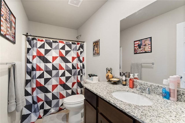 bathroom with toilet, a shower with curtain, tile patterned floors, and vanity