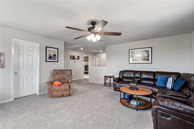 carpeted living area featuring a ceiling fan and baseboards