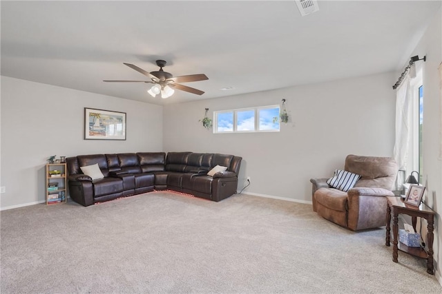 carpeted living area featuring baseboards, a ceiling fan, and visible vents