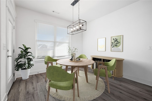 dining space with plenty of natural light and dark hardwood / wood-style flooring