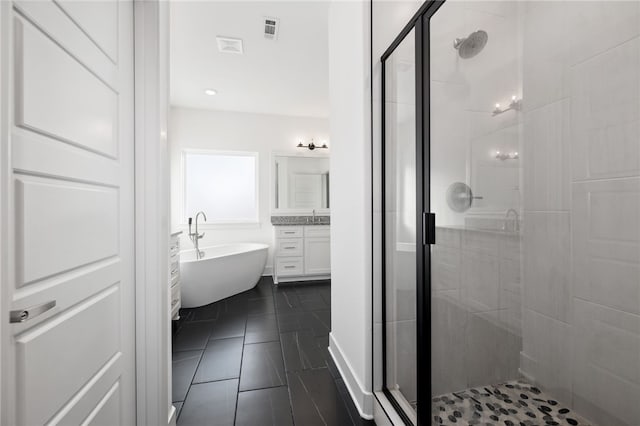 bathroom featuring separate shower and tub, vanity, and tile patterned floors