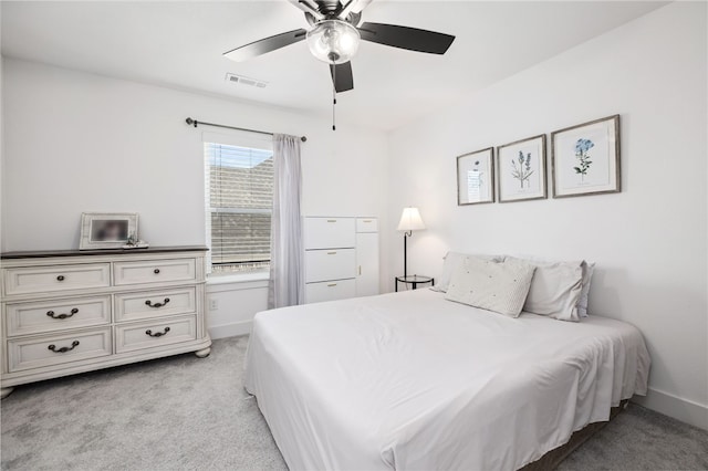 bedroom with ceiling fan and light carpet