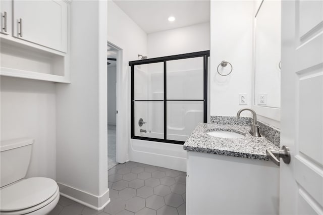 full bathroom with toilet, vanity, combined bath / shower with glass door, and tile patterned flooring