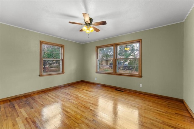 unfurnished room featuring ceiling fan, crown molding, and light hardwood / wood-style floors