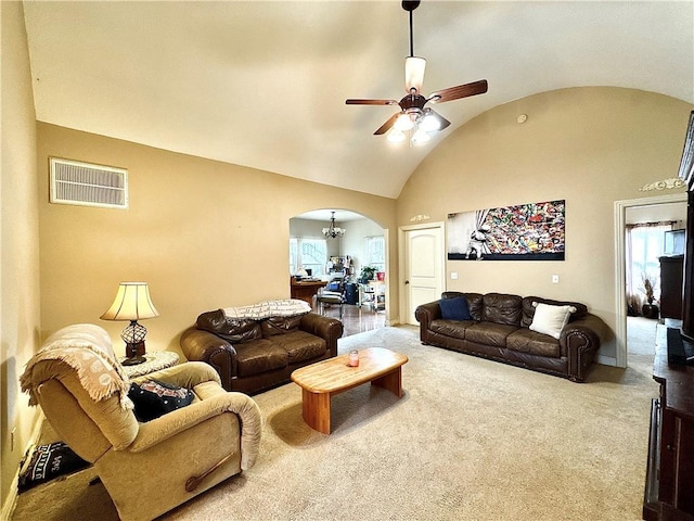 carpeted living room featuring arched walkways, visible vents, vaulted ceiling, and ceiling fan with notable chandelier