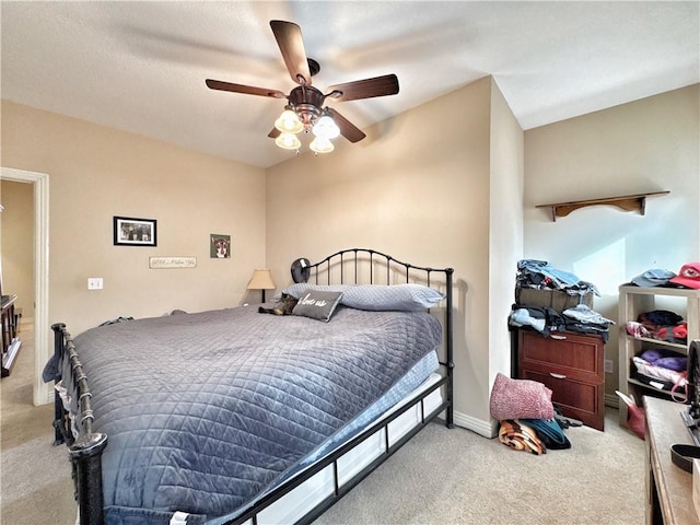 bedroom with ceiling fan, carpet flooring, and baseboards