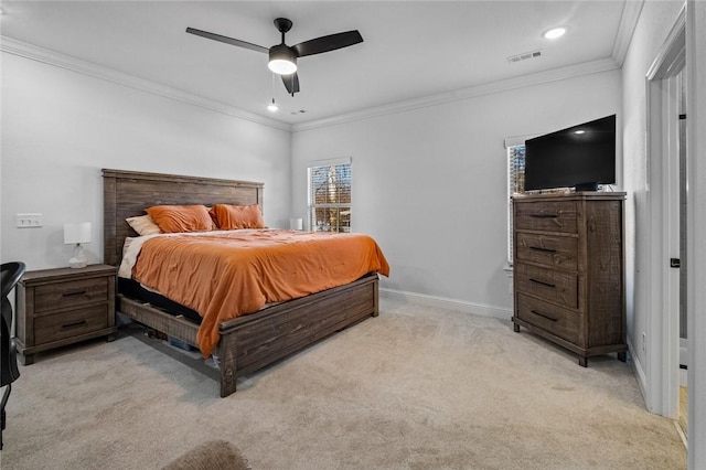 carpeted bedroom with ceiling fan and ornamental molding