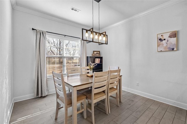 dining room with an inviting chandelier and crown molding