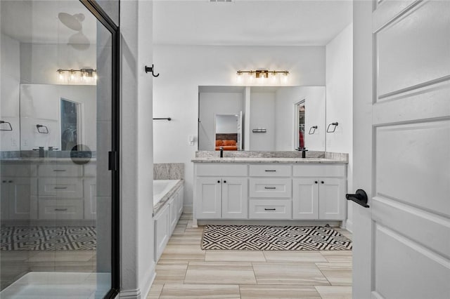 bathroom featuring vanity, tile patterned flooring, and shower with separate bathtub