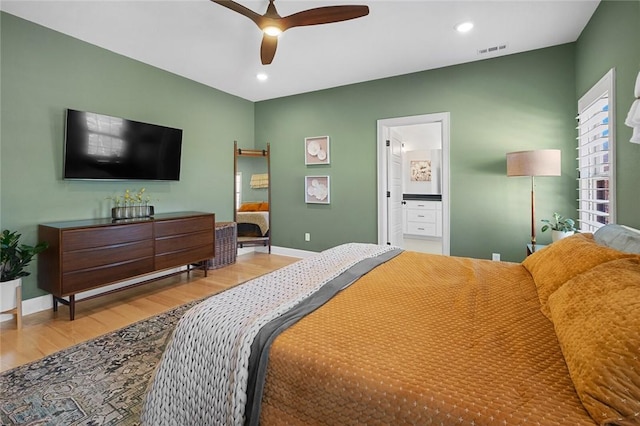 bedroom featuring ceiling fan, connected bathroom, and wood-type flooring