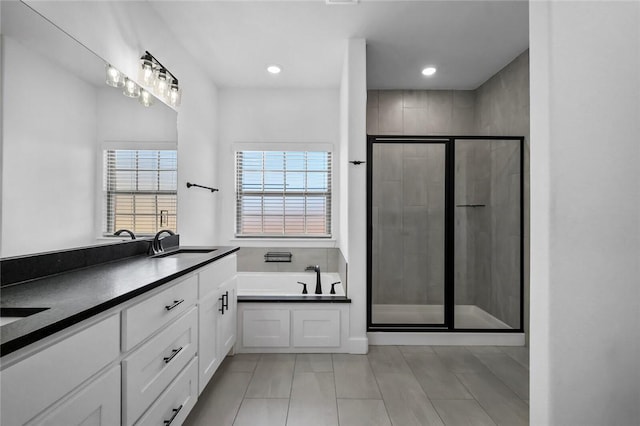 bathroom with vanity, tile patterned floors, and independent shower and bath