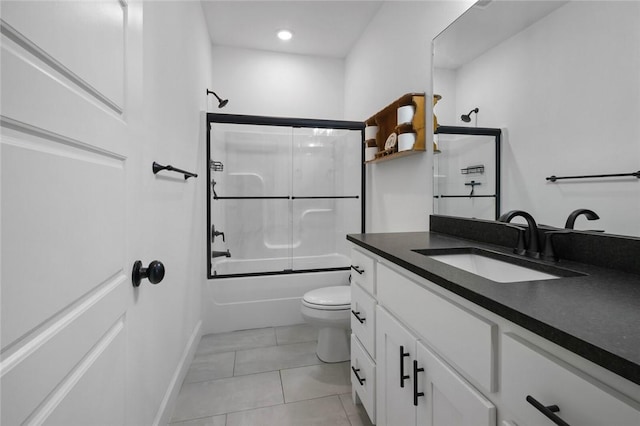 full bathroom featuring toilet, tile patterned floors, vanity, and shower / bath combination with glass door