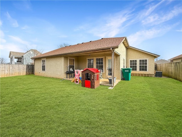 rear view of property with a yard