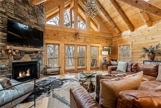 living room with hardwood / wood-style floors, beamed ceiling, wood ceiling, a fireplace, and high vaulted ceiling