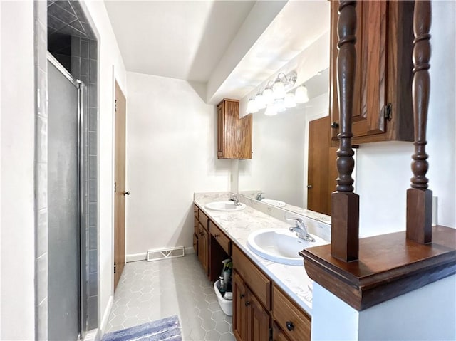 bathroom with walk in shower, vanity, and tile patterned flooring