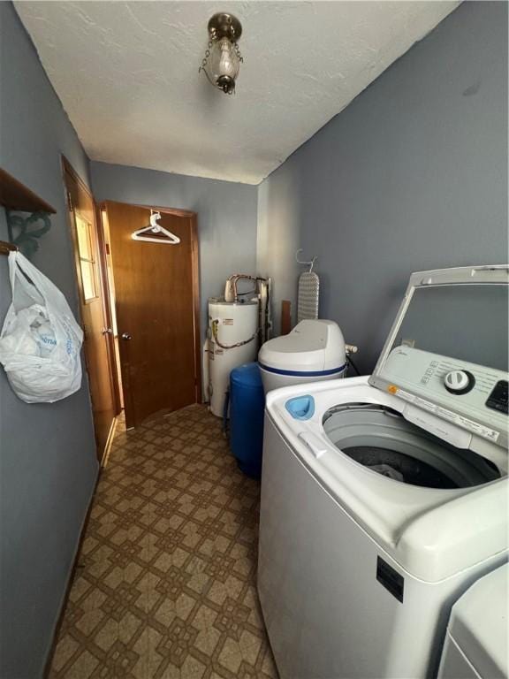 laundry room featuring water heater and washing machine and clothes dryer