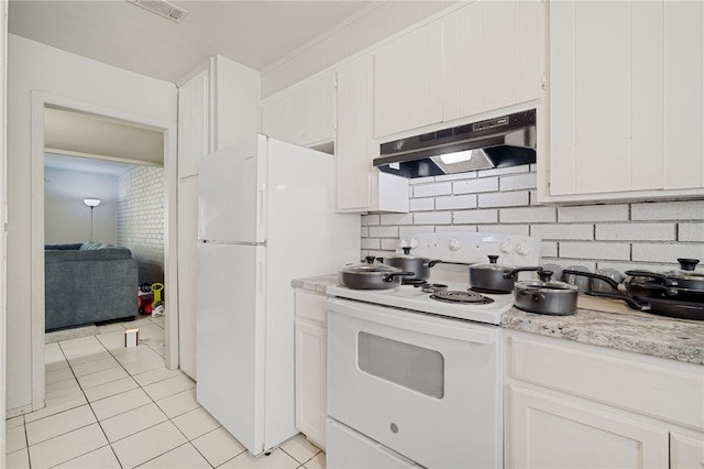 kitchen with light tile patterned floors, white cabinetry, tasteful backsplash, and white appliances