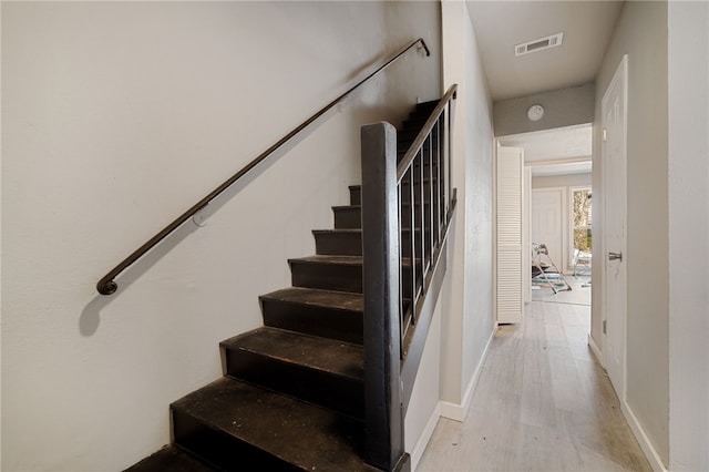 stairs with hardwood / wood-style floors