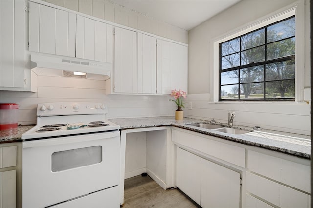 kitchen with white electric range, sink, light hardwood / wood-style flooring, white cabinets, and light stone counters