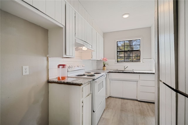 kitchen with white cabinetry, dark stone counters, sink, light wood-type flooring, and electric range