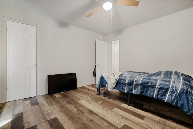 bedroom with ceiling fan and hardwood / wood-style flooring