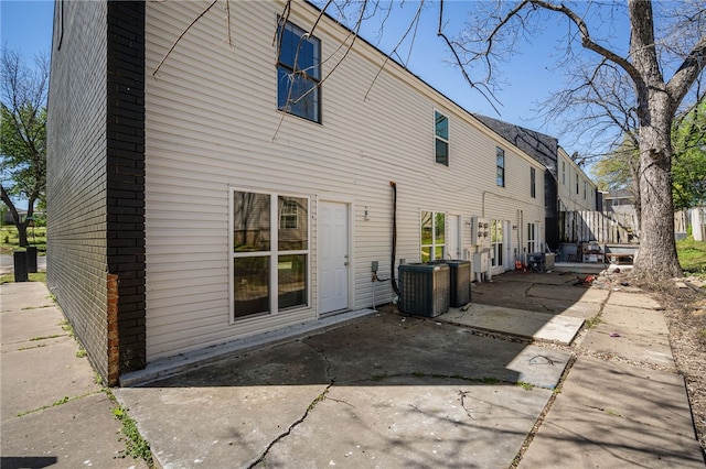 rear view of house featuring central AC and a patio area