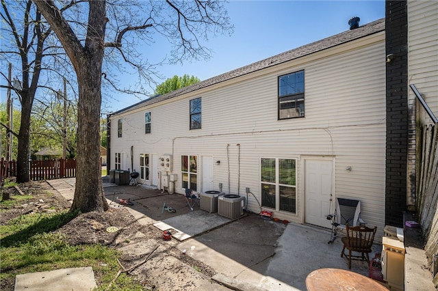 rear view of property featuring a patio area and cooling unit