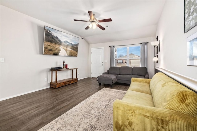 living room with a ceiling fan, vaulted ceiling, baseboards, and wood finished floors